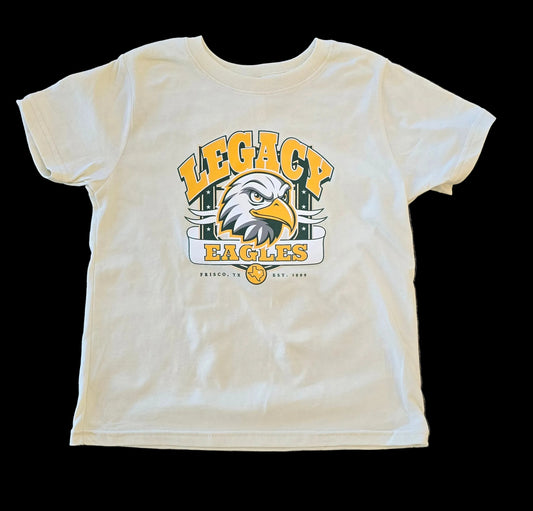 White t-shirt with 'Legacy Eagles' graphic on a textured surface